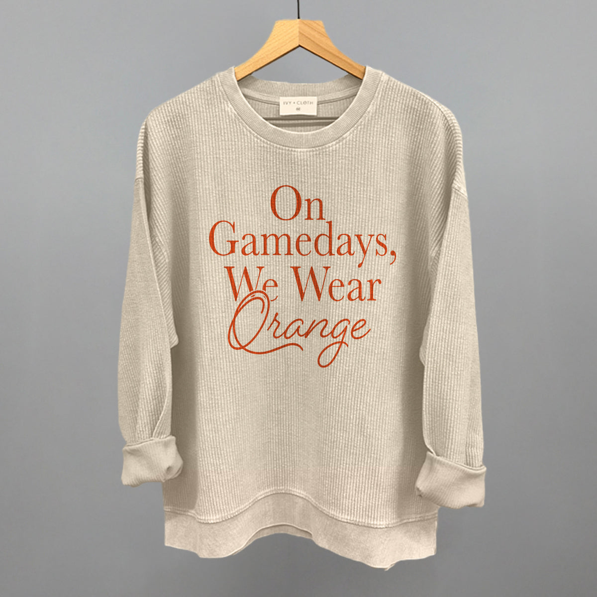 On Gamedays We Wear Orange design on a moonbeam oversized corded crew