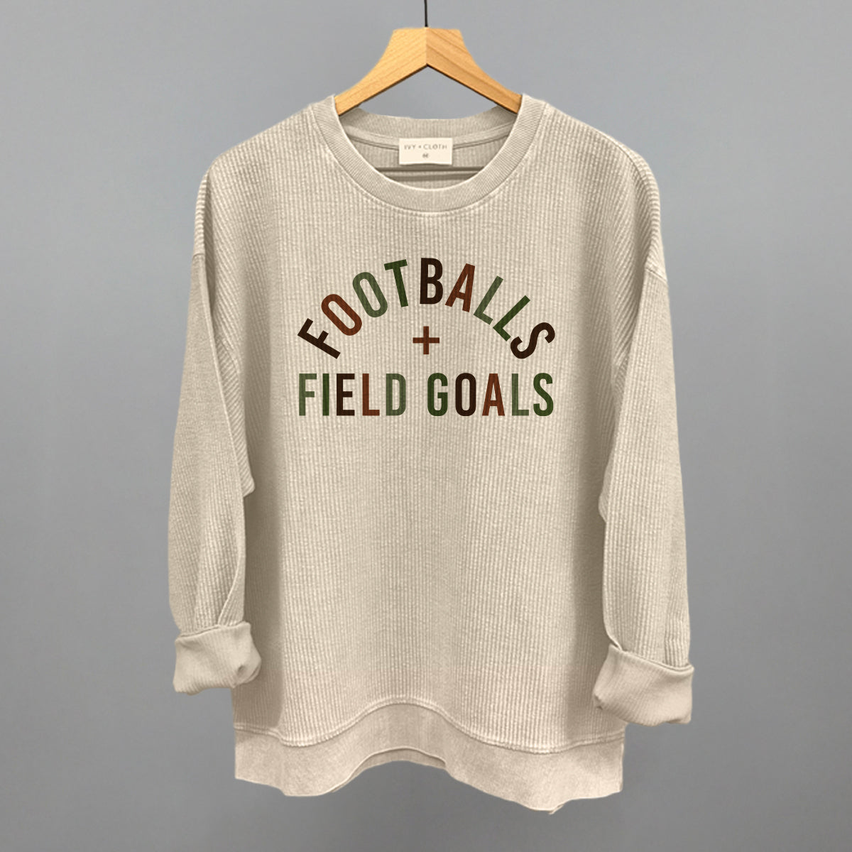 Footballs And Field Goals design on a moonbeam oversized corded crew