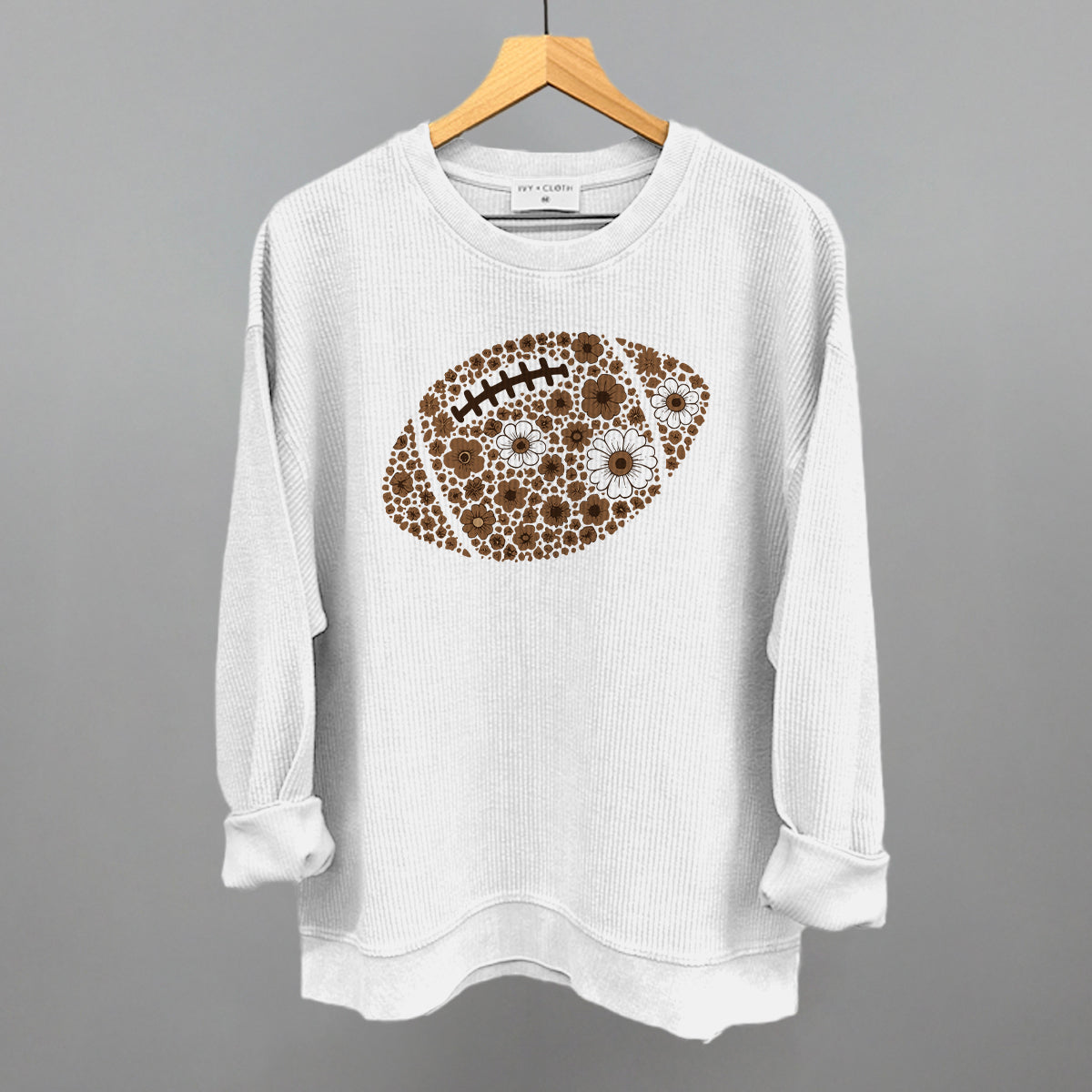 Brown floral football design on a white oversized corded crew
