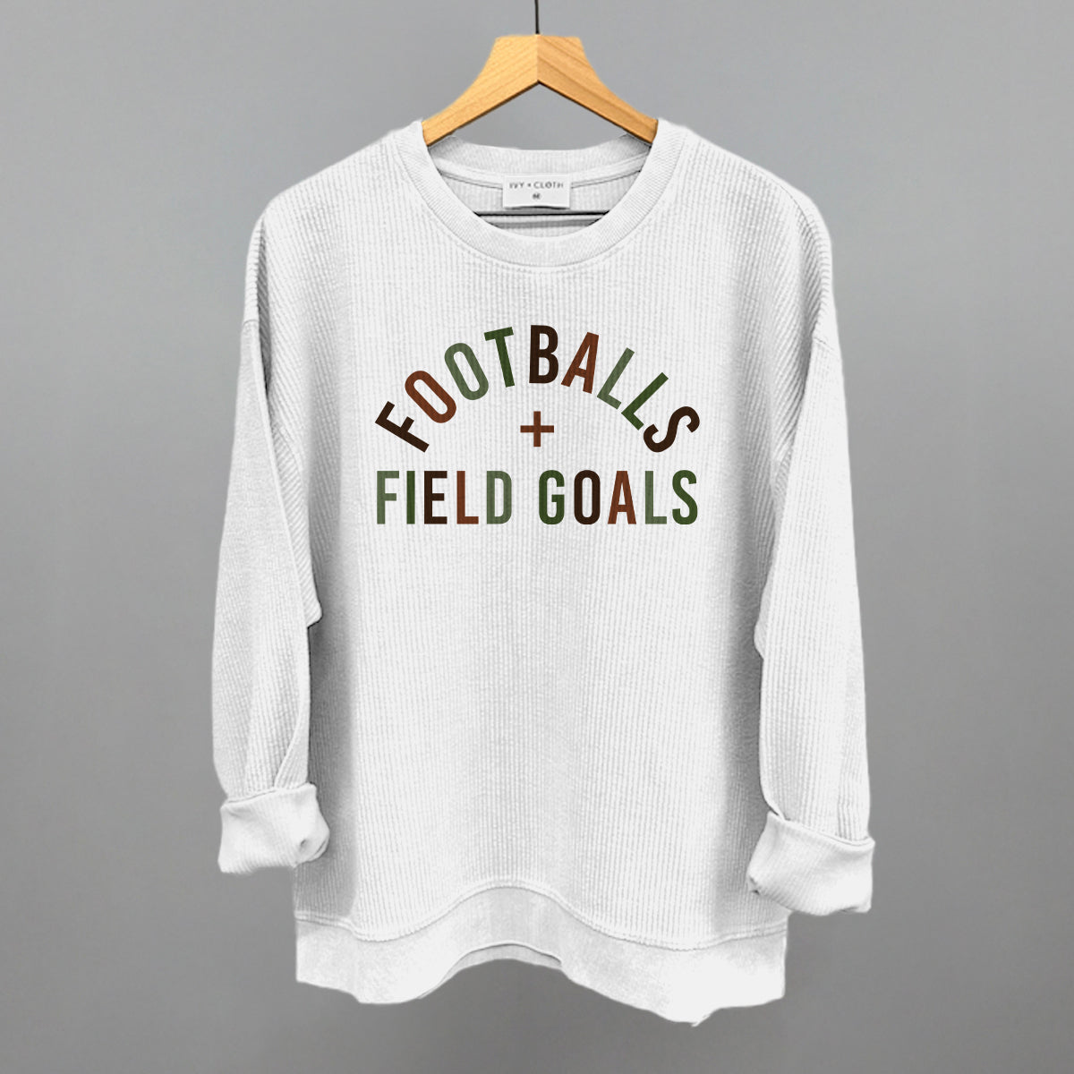 Footballs And Field Goals design on a white oversized corded crew