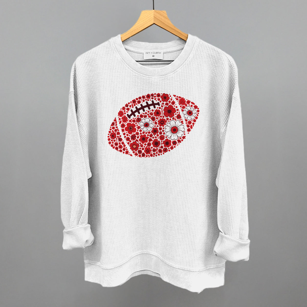 Red floral football design on a white oversized corded crew