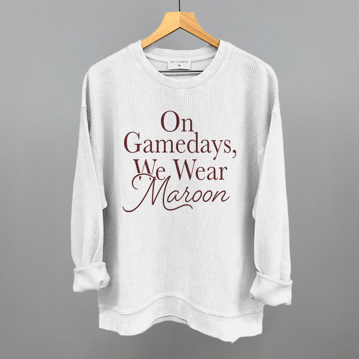 On Gamedays We Wear Maroon design on a white oversized corded crew