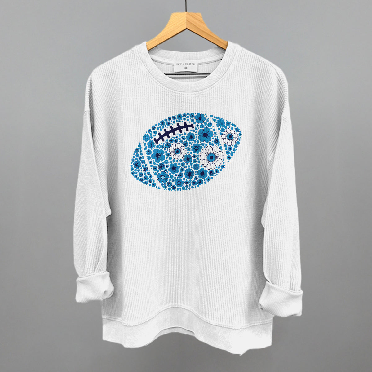 Blue floral football design on a white oversized corded crew
