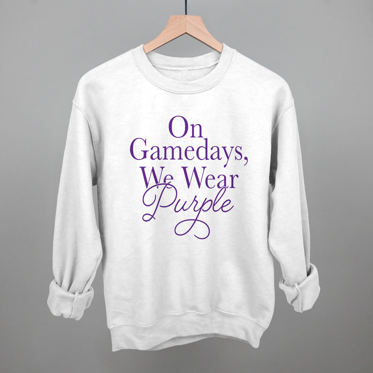 On Gamedays We Wear Purple design on a white fleece crewneck sweatshirt