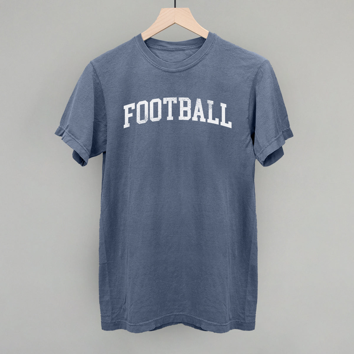 Distressed collegiate football design on a blue jean Comfort Colors tee