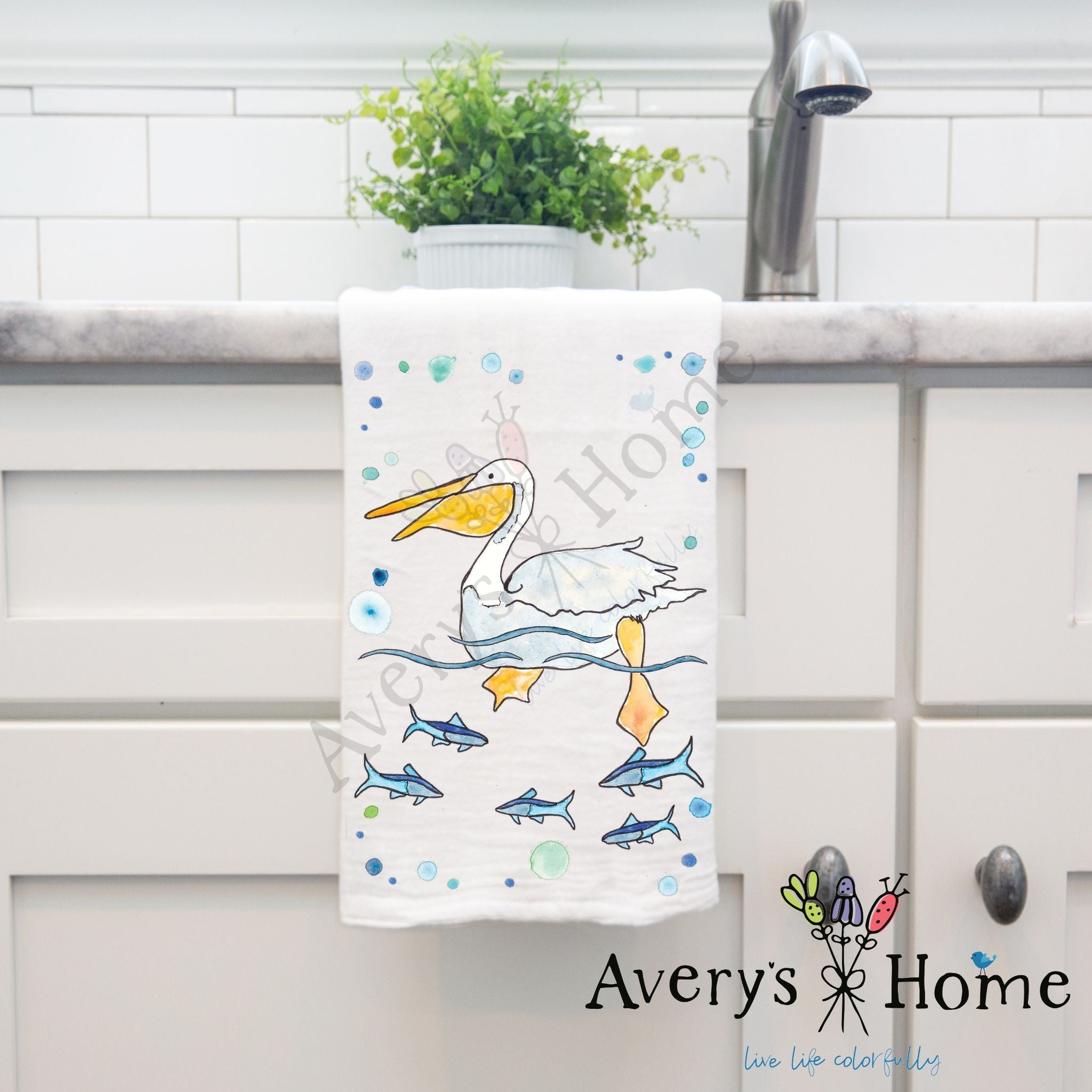 Pelican Swimming dish towel hanging in the kitchen