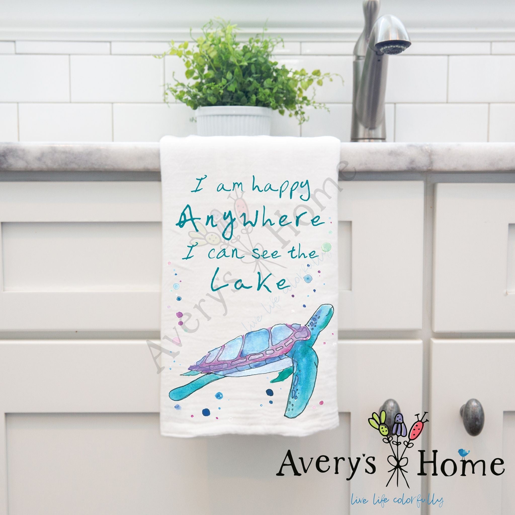 I Am Happy Anywhere Lake dish towel hanging by kitchen sink
