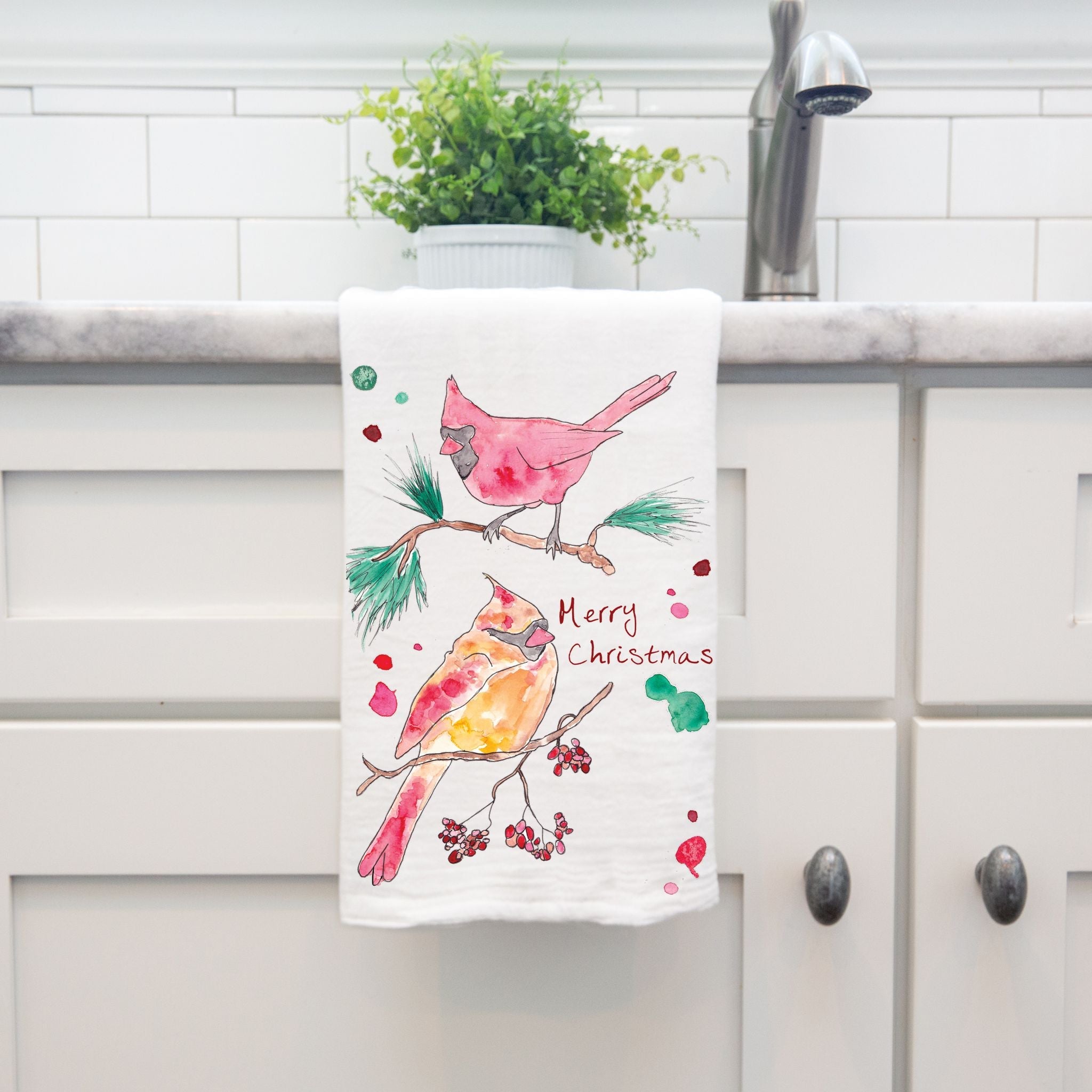 Cardinal Merry Christmas dish towel hanging by kitchen sink