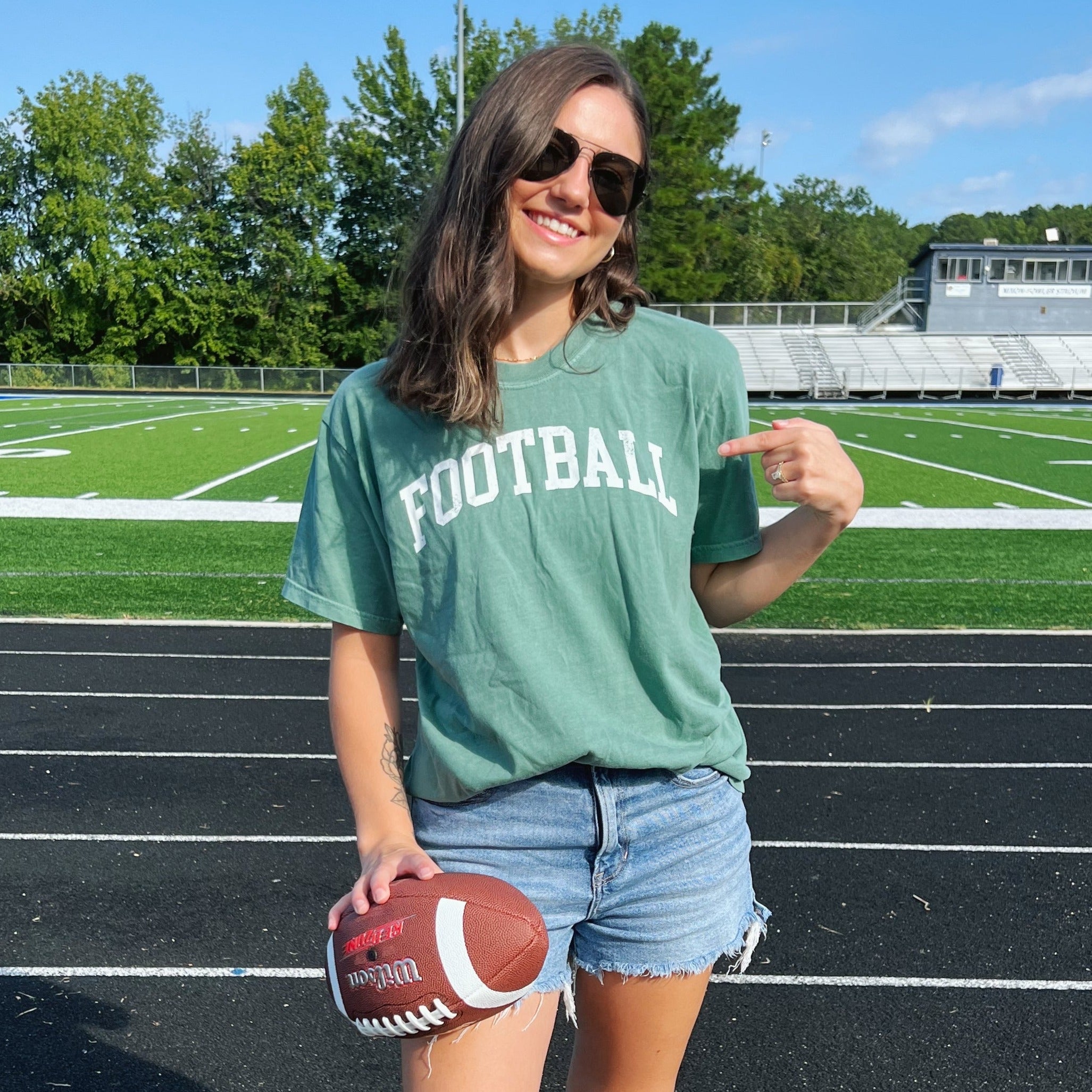 Distressed collegiate football design shown on a gameday top